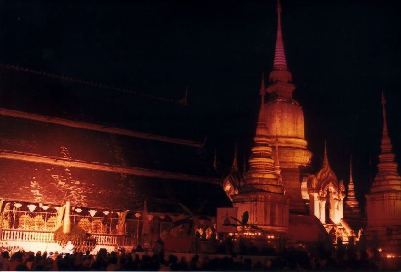 A golden Lanna chedi lit against the night sky during the World Festival of Sacred Music.