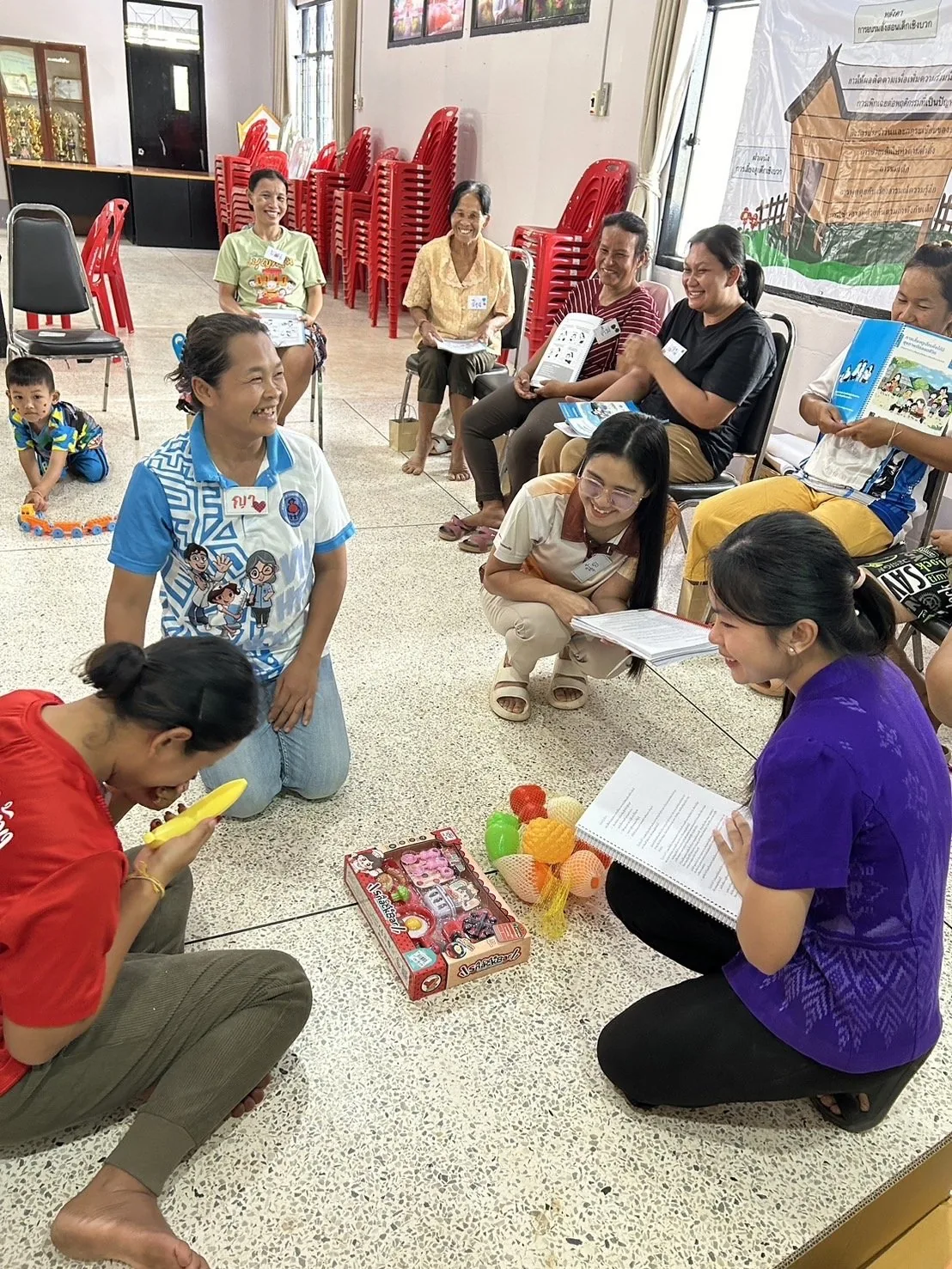 Parents and a facilitator sitting together during a parenting session